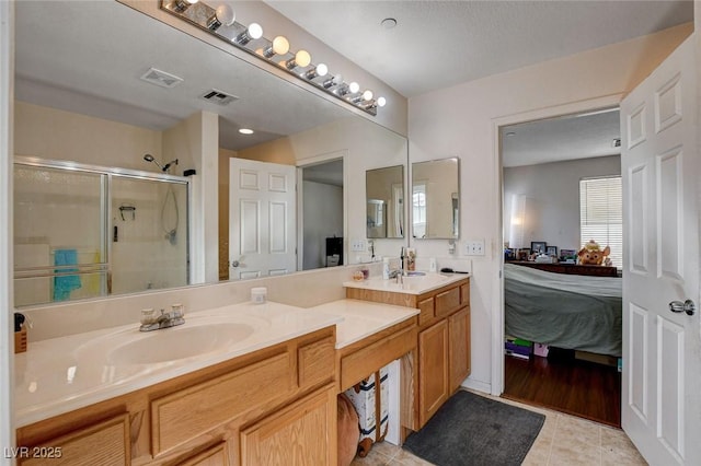 4777 Mereworth Ct, Las Vegas, NV 89130 - full bathroom with visible vents, a sink, double vanity, ensuite bath, and a stall shower