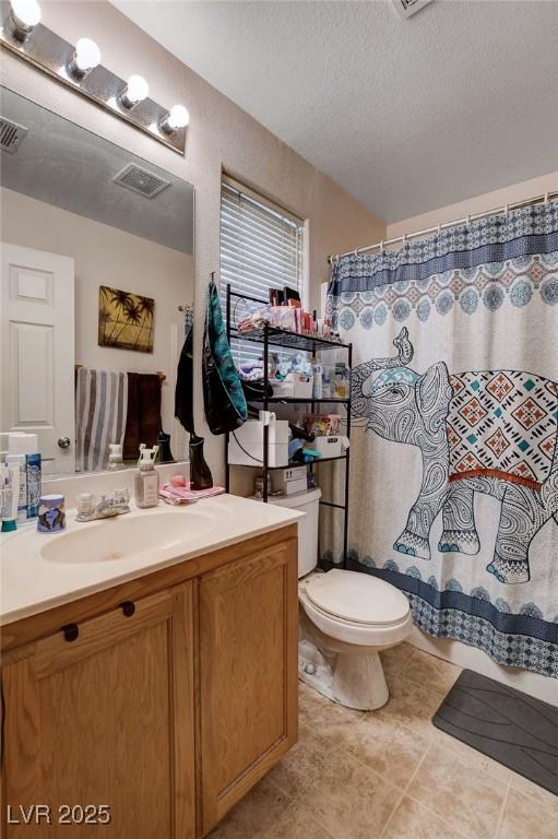 4777 Mereworth Ct, Las Vegas, NV 89130 - full bathroom with tile patterned flooring, vanity, visible vents, and toilet