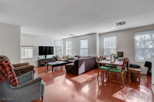 4777 Mereworth Ct, Las Vegas, NV 89130 - living area with wood finished floors, visible vents, and plenty of natural light