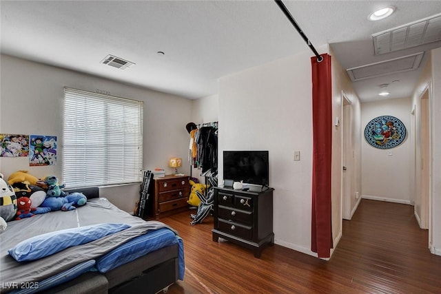4777 Mereworth Ct, Las Vegas, NV 89130 - bedroom featuring visible vents, baseboards, attic access, and wood finished floors