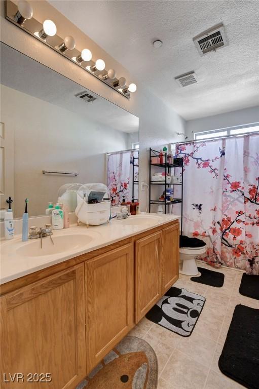 4777 Mereworth Ct, Las Vegas, NV 89130 - full bathroom with double vanity, visible vents, and a sink