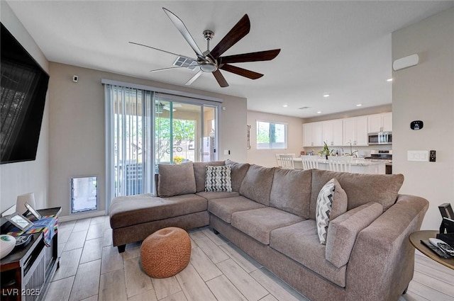 living room featuring ceiling fan and recessed lighting