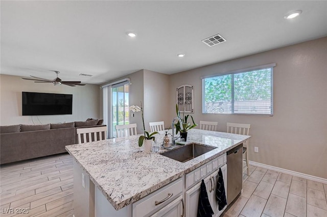 kitchen with plenty of natural light, visible vents, stainless steel dishwasher, and a sink