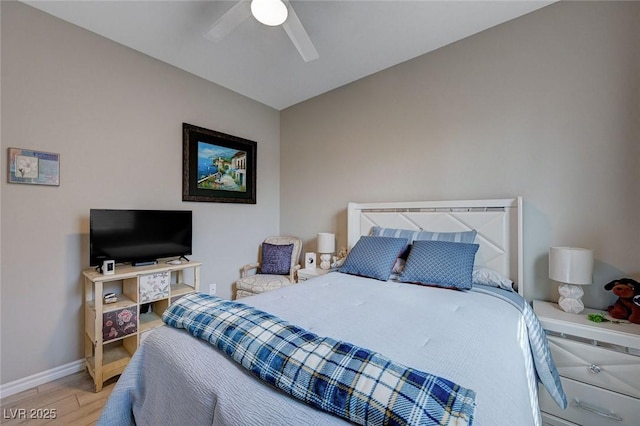 bedroom featuring baseboards, a ceiling fan, and wood finished floors