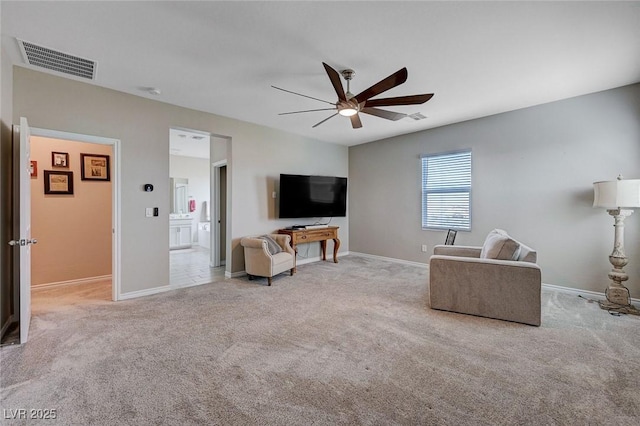 carpeted living area with baseboards, visible vents, and ceiling fan