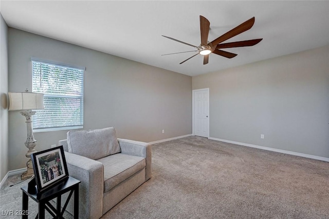 sitting room with carpet floors, baseboards, and ceiling fan