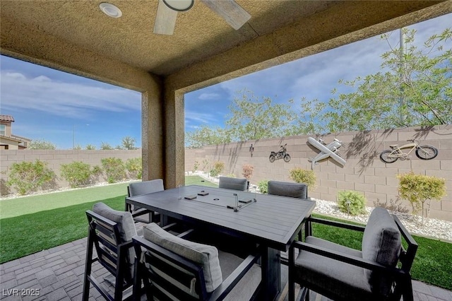 view of patio featuring a ceiling fan, a fenced backyard, and outdoor dining area