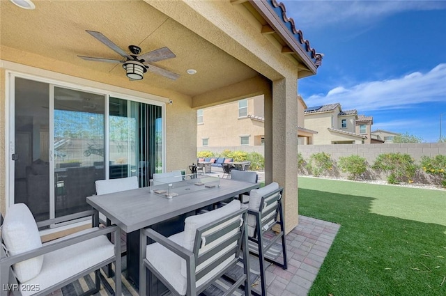 view of patio / terrace featuring fence, ceiling fan, and outdoor dining space