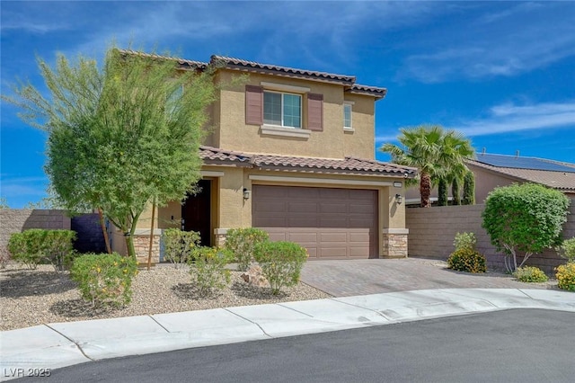 mediterranean / spanish home featuring stucco siding, a tile roof, decorative driveway, and an attached garage