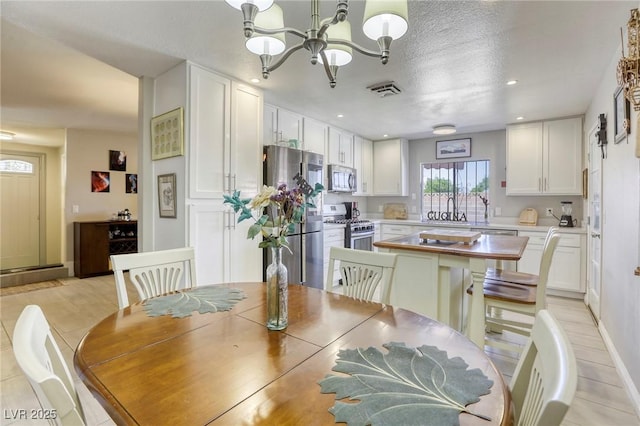 dining area with baseboards, visible vents, recessed lighting, and a notable chandelier