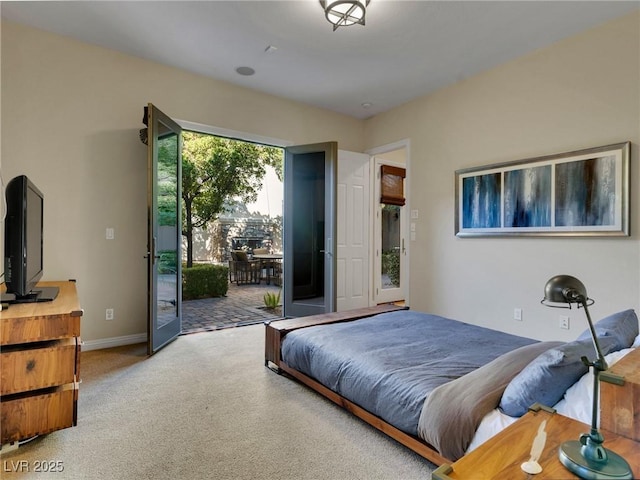 bedroom with carpet floors, baseboards, and access to outside