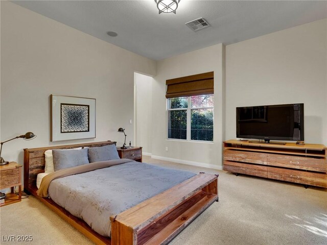 carpeted bedroom featuring baseboards and visible vents