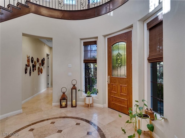 entryway with plenty of natural light and baseboards