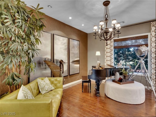 sitting room featuring wood finished floors, a chandelier, baseboards, visible vents, and recessed lighting