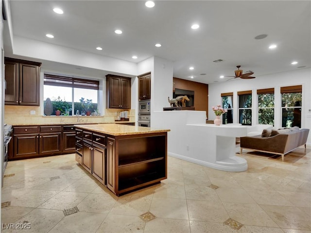 kitchen with open floor plan, appliances with stainless steel finishes, and recessed lighting