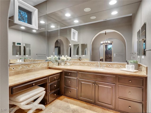 bathroom featuring vanity, a chandelier, and recessed lighting