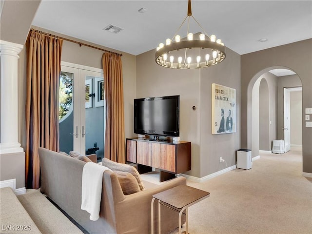 living room featuring light carpet, french doors, arched walkways, visible vents, and baseboards