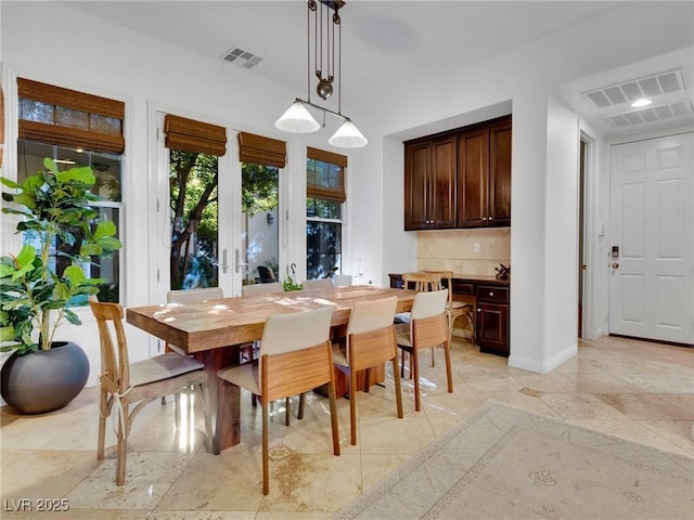 dining room featuring visible vents, baseboards, and french doors