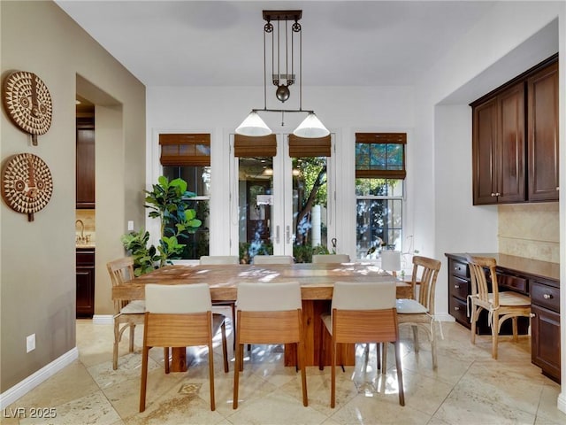 dining space featuring baseboards