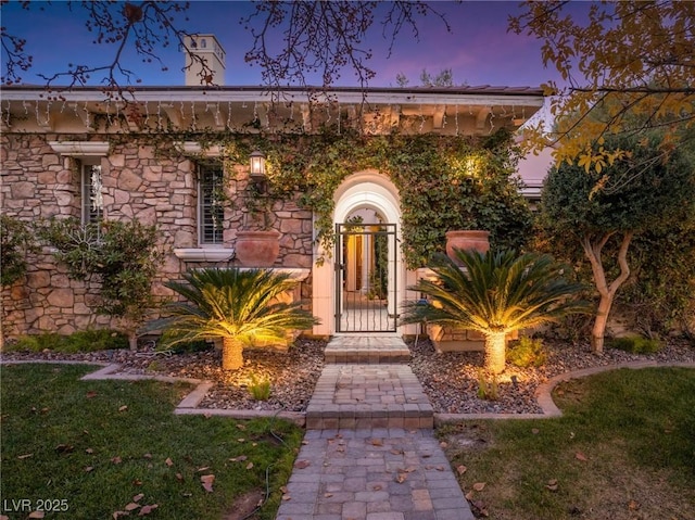 property entrance featuring stone siding