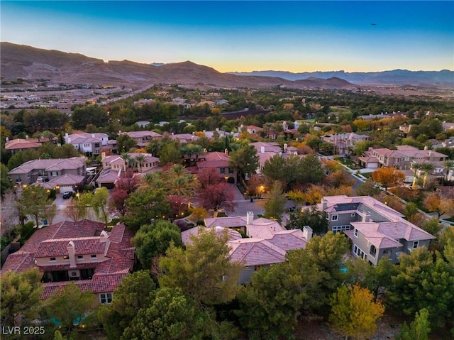 aerial view at dusk featuring a residential view and a mountain view