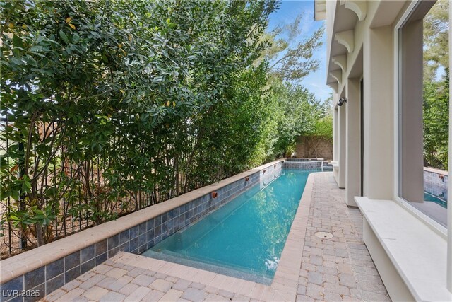 view of pool with a pool with connected hot tub