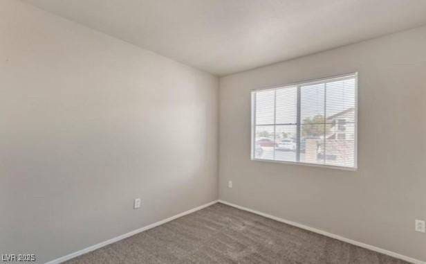 carpeted spare room with baseboards
