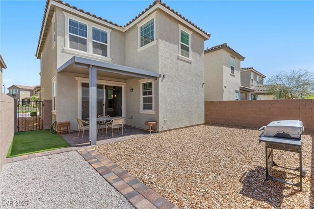 2293 Teatro Ave, Henderson, NV 89044 - back of property with fence, a patio, stucco siding, and a tiled roof