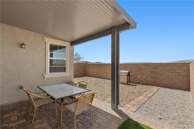 2293 Teatro Ave, Henderson, NV 89044 - view of patio with a fenced backyard, outdoor dining area, and grilling area