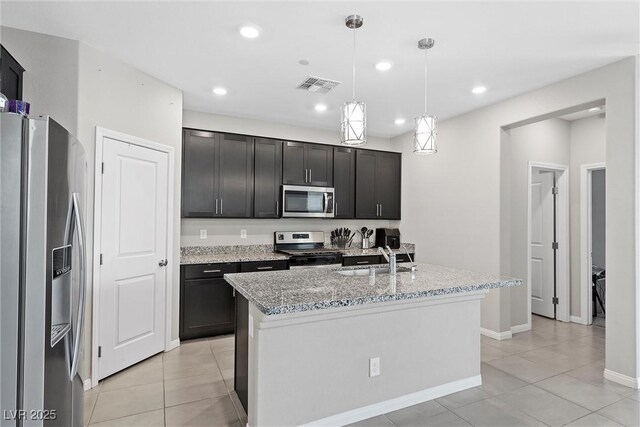 2293 Teatro Ave, Henderson, NV 89044 - kitchen with visible vents, light stone countertops, a sink, stainless steel appliances, and light tile patterned flooring