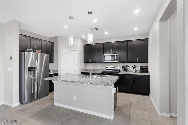2293 Teatro Ave, Henderson, NV 89044 - kitchen featuring pendant lighting, light stone countertops, a sink, dark cabinets, and stainless steel appliances