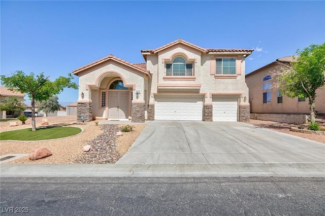 mediterranean / spanish-style home with stucco siding, an attached garage, driveway, and a tiled roof