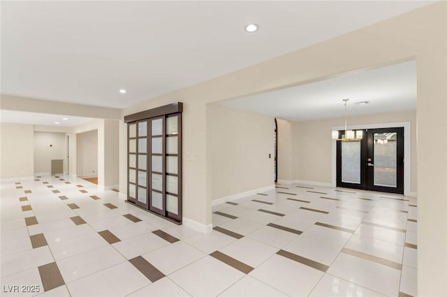 tiled spare room with baseboards, french doors, and recessed lighting
