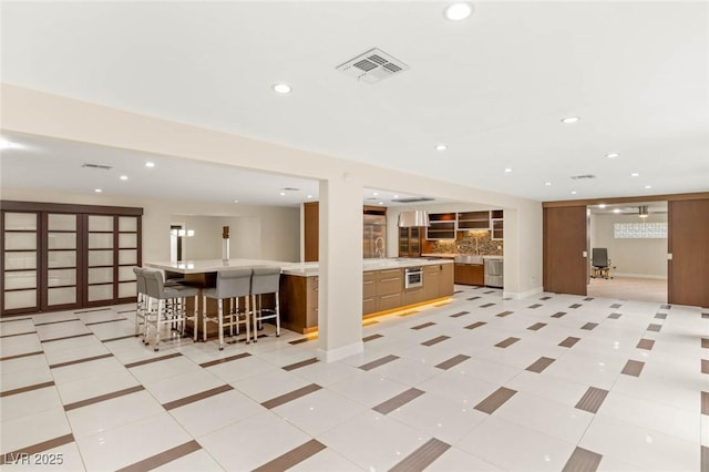 interior space featuring light countertops, visible vents, and recessed lighting