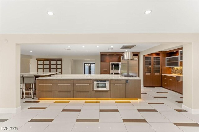kitchen with recessed lighting, appliances with stainless steel finishes, and modern cabinets