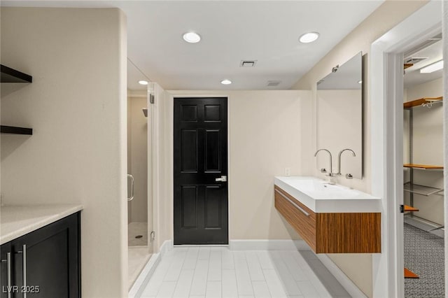 full bathroom with baseboards, recessed lighting, tile patterned flooring, a shower stall, and vanity