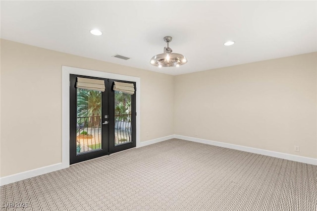 carpeted spare room featuring baseboards, french doors, visible vents, and recessed lighting