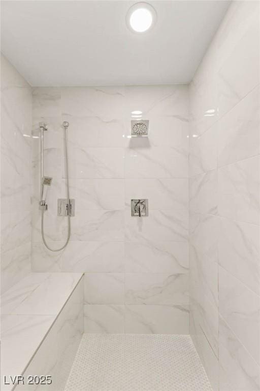 full bathroom featuring a marble finish shower