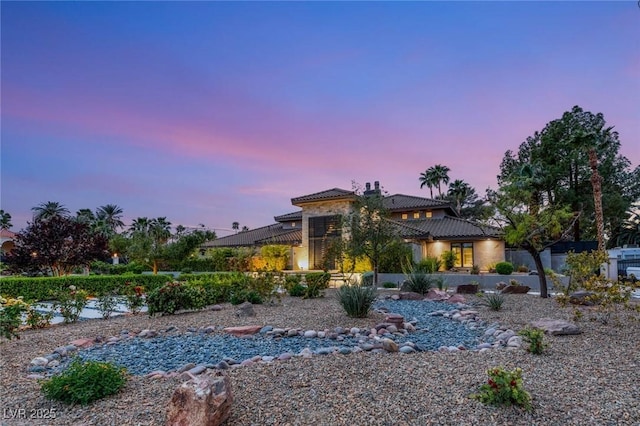 view of front of home with a tiled roof and stucco siding