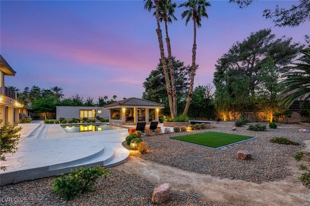 exterior space featuring a pool, fence, a storage structure, an outbuilding, and a patio