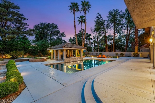 view of swimming pool with a fenced in pool, fence, a storage structure, an outdoor structure, and a patio