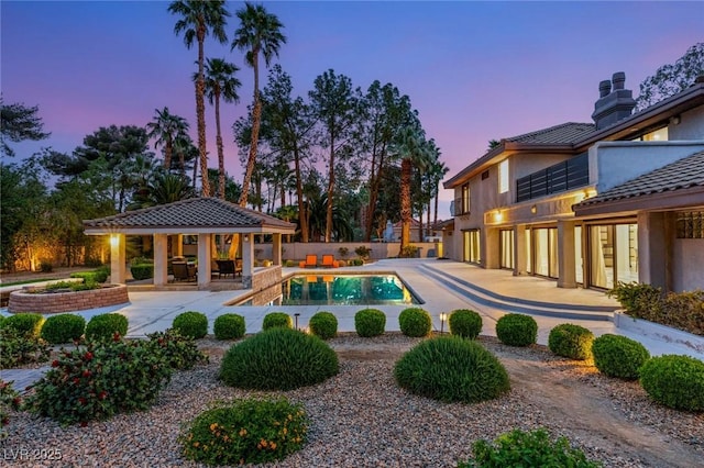 outdoor pool featuring a gazebo, a patio area, and fence