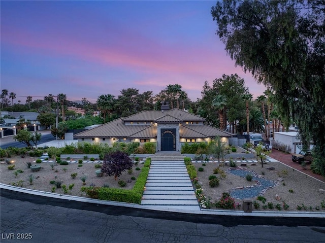 view of front of house with a tiled roof and stucco siding