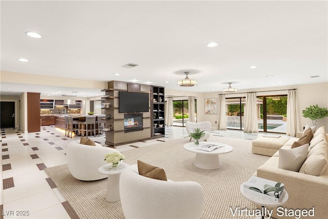 living room with recessed lighting, a wealth of natural light, and visible vents