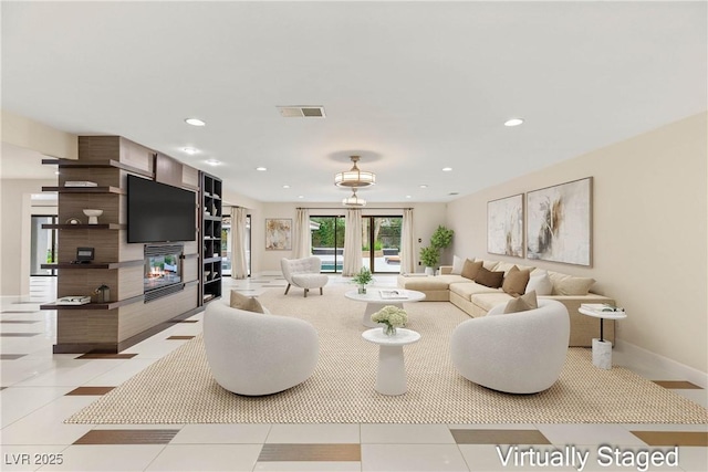 living area with light tile patterned flooring, baseboards, visible vents, recessed lighting, and a multi sided fireplace
