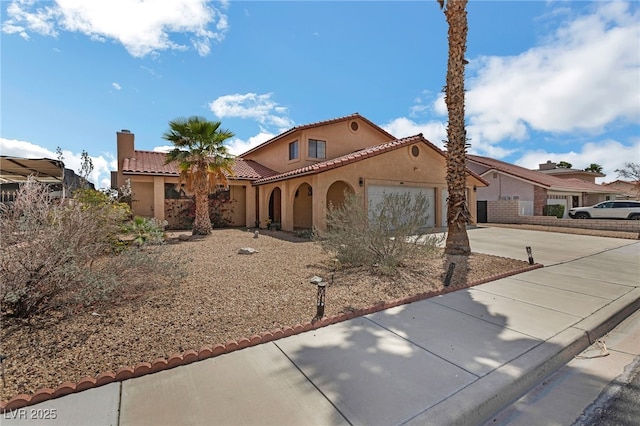 2111 River City Dr, Laughlin, NV 89029 - mediterranean / spanish house featuring concrete driveway, stucco siding, an attached garage, and a tile roof