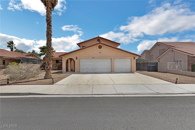 2111 River City Dr, Laughlin, NV 89029 - mediterranean / spanish-style house with an attached garage, driveway, fence, and stucco siding