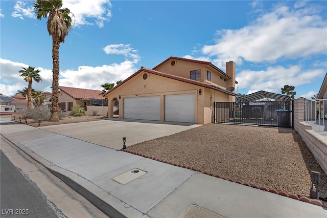 2111 River City Dr, Laughlin, NV 89029 - view of front of home with a gate, driveway, an attached garage, fence, and stucco siding