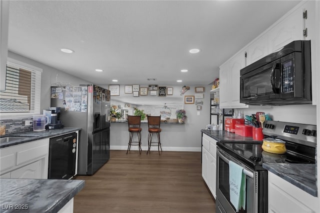 2111 River City Dr, Laughlin, NV 89029 - kitchen with black appliances, dark countertops, white cabinetry, recessed lighting, and dark wood-style floors