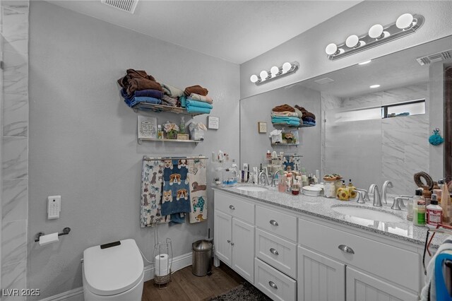 2111 River City Dr, Laughlin, NV 89029 - bathroom featuring toilet, wood finished floors, double vanity, and a shower